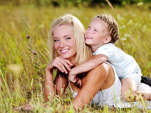 Happiness of the  mother and daughter - people on nature