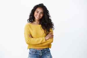 Free photo happiness, wellbeing and confidence concept. cheerful attractive african american woman curly haircut, cross arms chest in self-assured powerful pose, smiling determined, wear yellow sweater