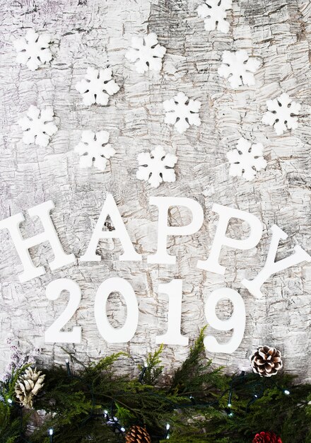 Happy 2019 inscription with branches