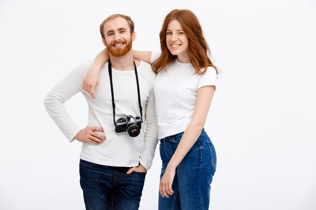 Happy adult couple posing with photo camera