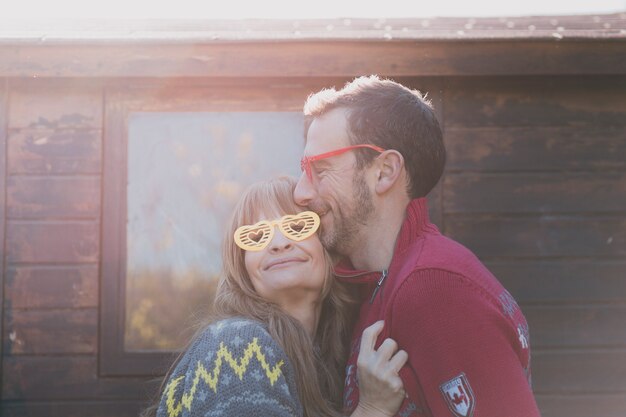 Happy adult couple with heart glasses