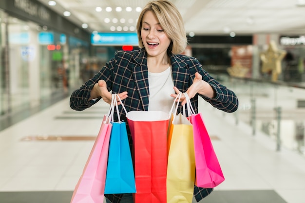 Happy adult woman holding shopping bags