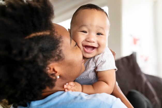 Happy African American mother kissing her son