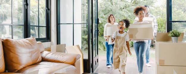 Happy African American young family bought new house.