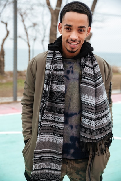 Happy african american young man standing outdoors