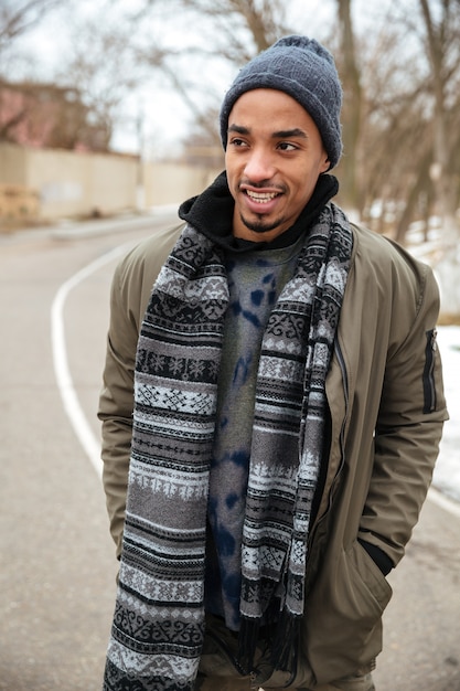 Happy african man walking on the road outdoors