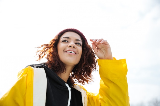 Happy african young lady walking outdoors