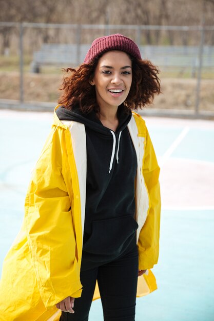 Happy african young lady walking outdoors