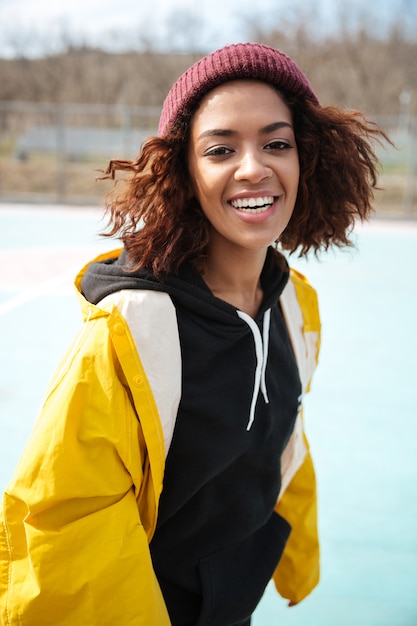 Happy african young lady walking outdoors