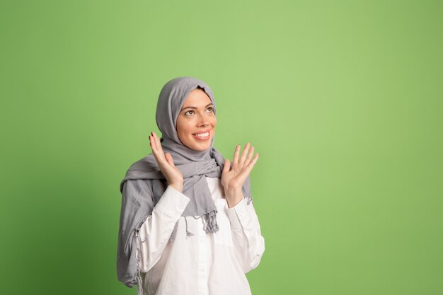 Happy arab woman in hijab. Portrait of smiling girl, posing at studio background