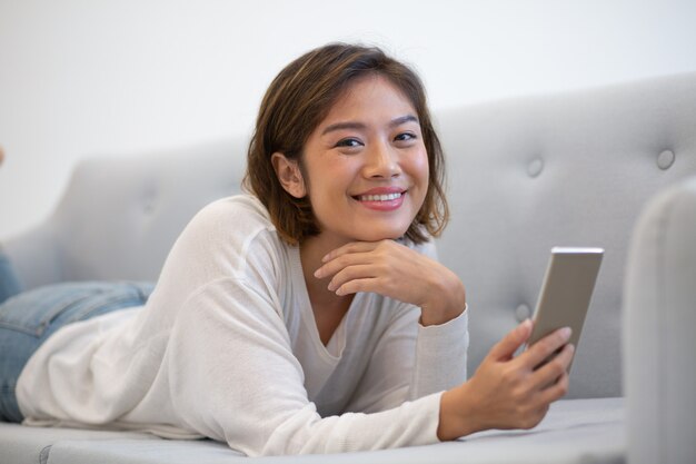 Happy Asian phone user getting good news