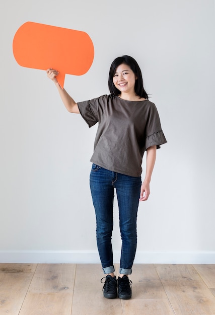 Happy Asian woman holding copyspace speech bubble