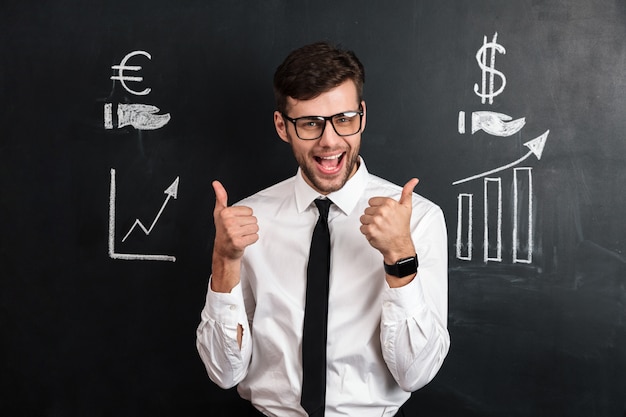 Happy attractive businessman in white shirt showing thumb up gesture with two hands