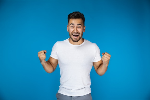 Happy attractive guy on the blue background