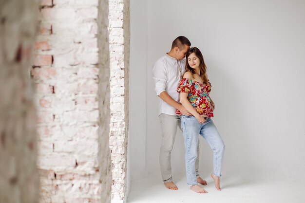 Happy and attractive pregnant couple posing