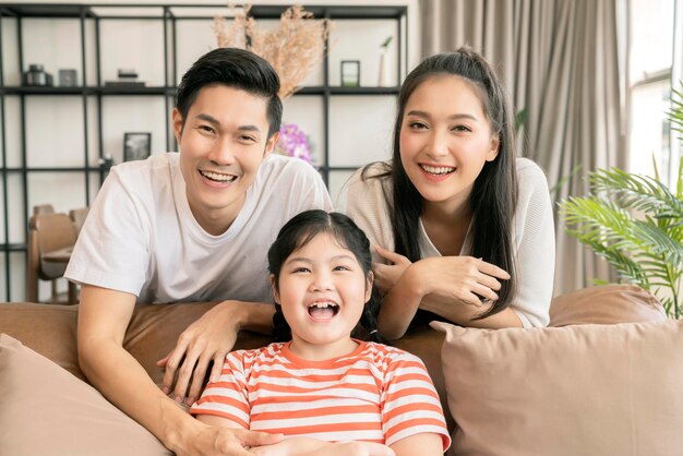 Happy Attractive Young asian Family Portrait Healthy harmony in life family day concept asian family man woman and little girl having good time together