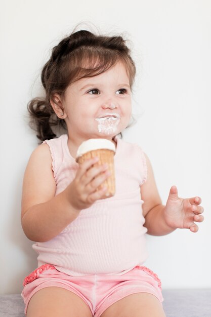 happy baby girl eating an ice cream