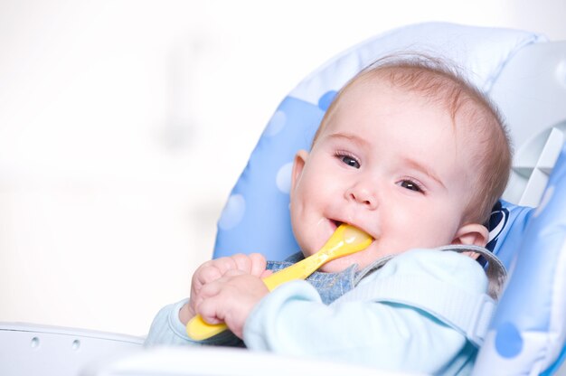 Happy baby with spoon