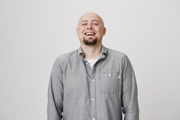 Happy bald adult man laughing