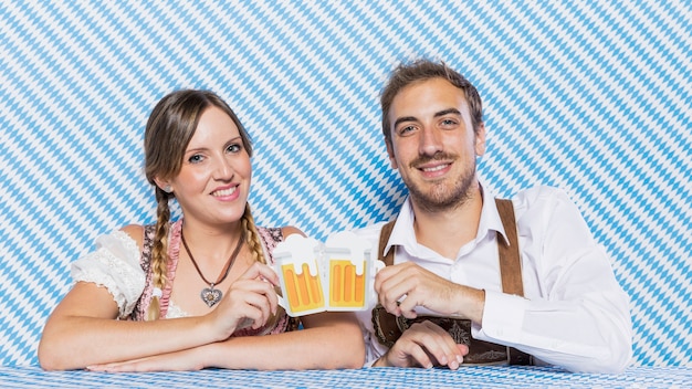 Happy bavarian friends with beer mugs