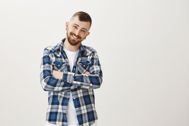 Happy bearded guy in casual closes looking enthusiastic