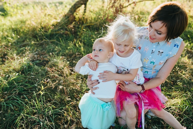 Happy beautiful family on the big garden on the dawn time