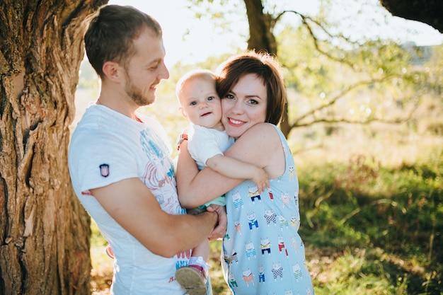 Happy beautiful family on the big garden on the dawn time