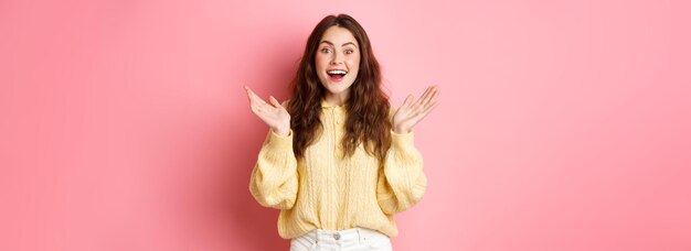 Free photo happy beautiful girl gasping amazed clap hands and smiling looking surprised receive great news bein