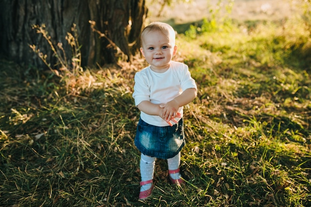 Happy beautiful kid on the big garden on the dawn time