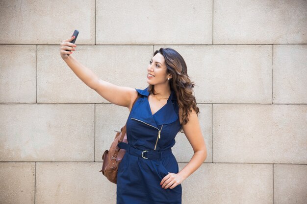 Happy beautiful lady posing for self-portrait