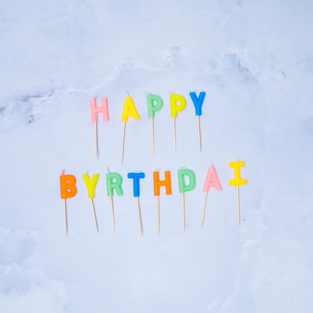 Happy birthday colorful candles on marble background