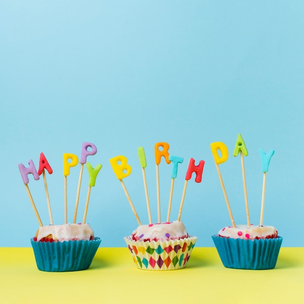 Happy birthday lettering on cupcakes