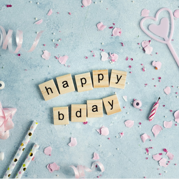 Free photo happy birthday wish in wooden letters with ribbon