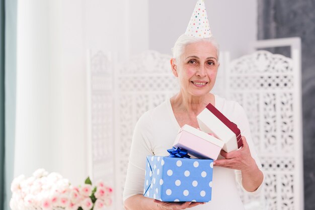 Happy birthday woman holding gift boxes