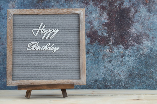 Happy birthday writing on the wooden desk