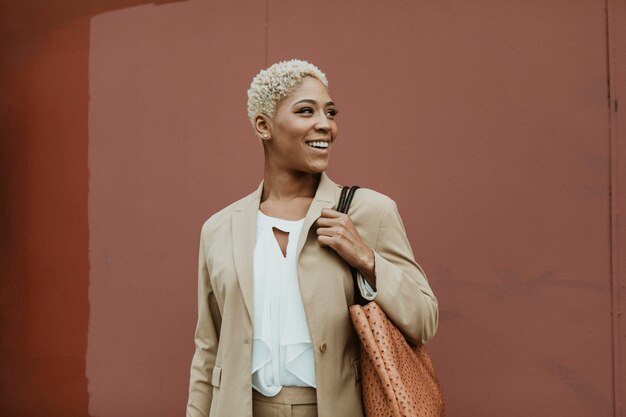 Happy black businesswoman strolling the streets