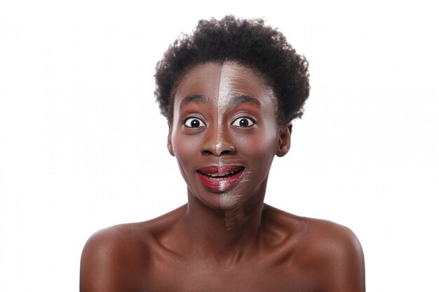 Happy black woman with half face on makeup, beauty concept
