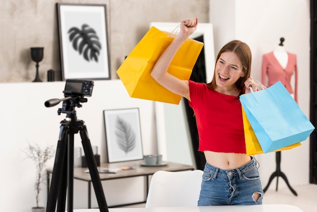Happy blogger holding shopping bags