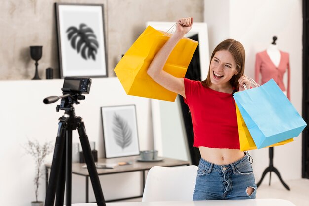 Happy blogger holding shopping bags