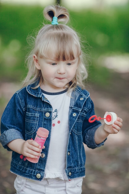 Happy blond girl with a pompous in hands