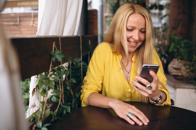 Happy blonde hair woman talking on phone