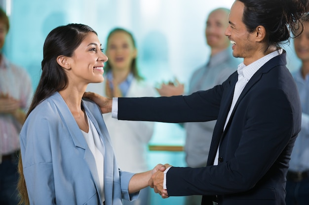 Free photo happy boss greeting new female manager