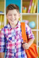 Free photo happy boy in the classroom