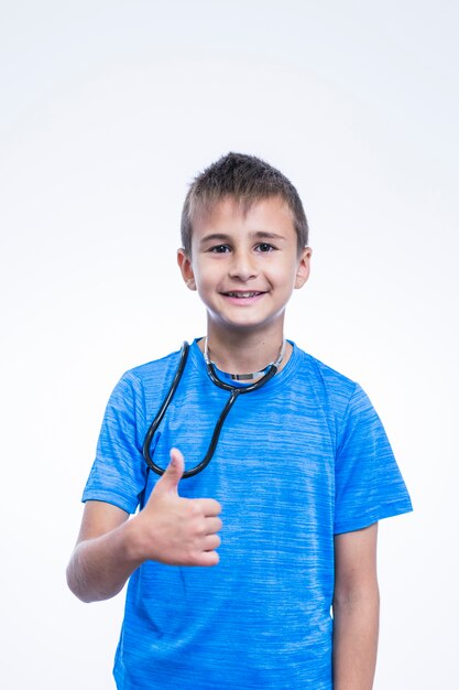 Happy boy gesturing thumbsup on white background