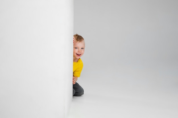 Happy boy isolated on  wall. Looks happy, cheerful. Copyspace Childhood, education, emotions, facial expression concept. Jumping high, playing having fun