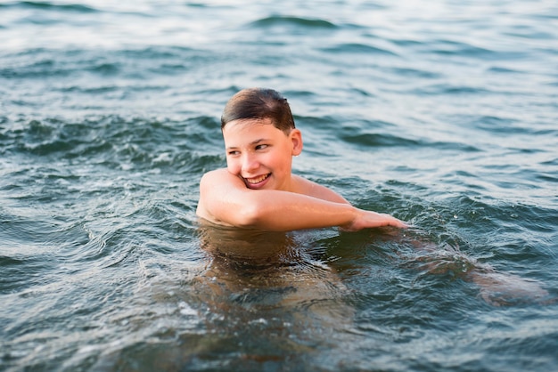 Happy boy swimming in the sea