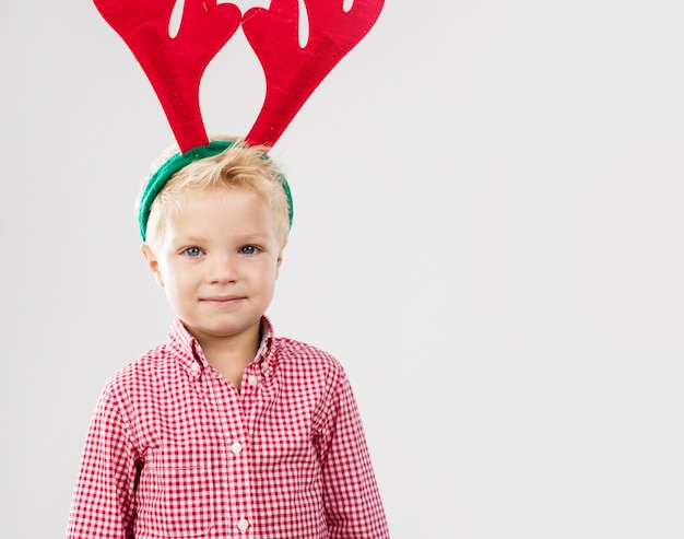 Happy boy with reindeer antlers