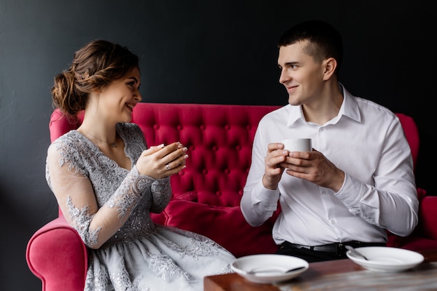 Happy bride and groom drink coffee and enjoy life