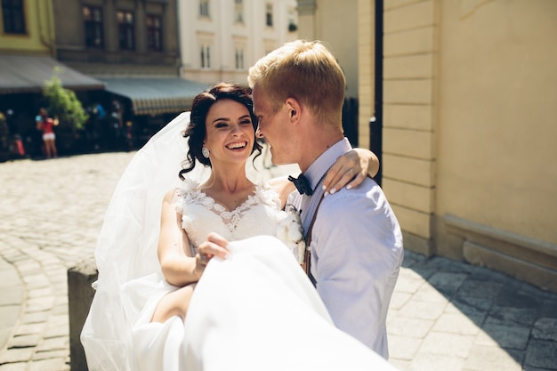 Happy bride in her groom's arms