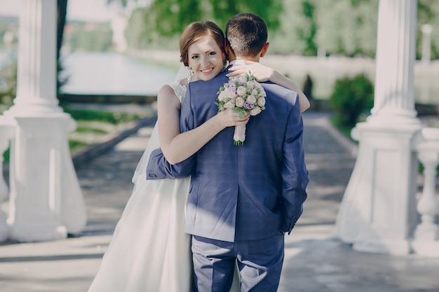 Happy bride hugging her groom